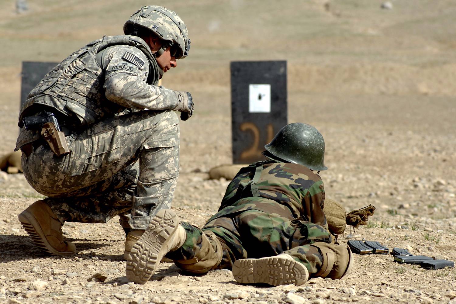 U.S. Army Staff Sgt. Derek Renaud, 34, of Angola, New York, looks on as an Afghan national army soldier tries zeroing his weapon at Kabul Military Training Center, March 17. Renaud, officer in charge of the range during qualification and zeroing of M16s, mentors ANA recruits as they learn to use their new M16s. He's a member of the Camp Alamo Mentor Group's Basic Warrior Training branch. Photo by Guy Volb. U.S. Army